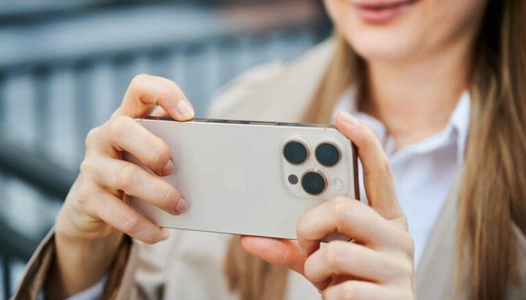 Mulher com celular, iPhone, câmera de celular - anatoliy_gleb / Shutterstock.com