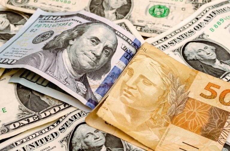 Dólar cai para menos de R$ 5 e juros futuros recuam após Flávio Bolsonaro liderar 1º turno